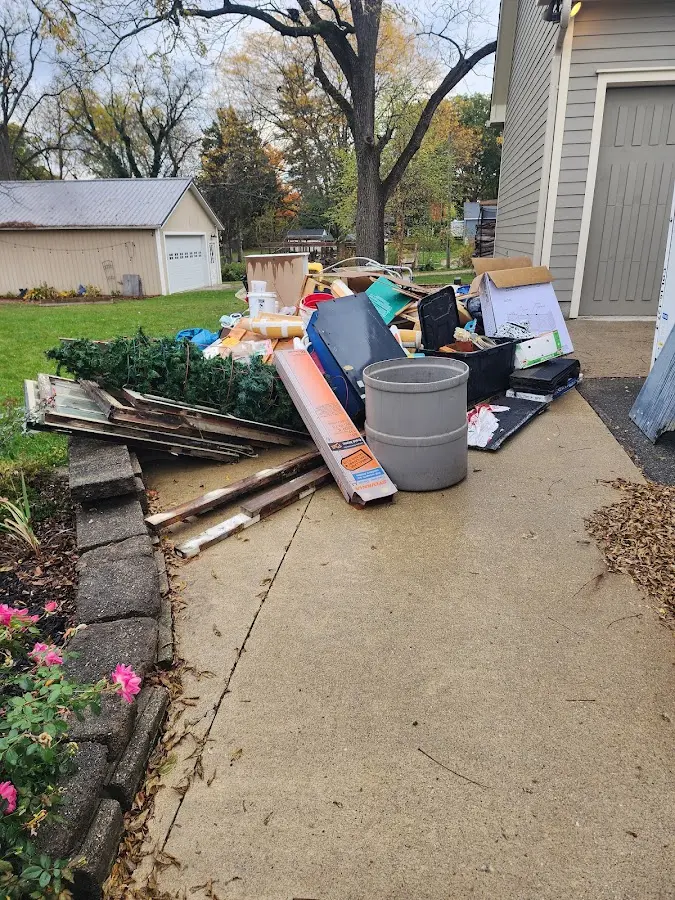 Dumpster being loaded with debris for Residential Dumpster Rental in Red Oak